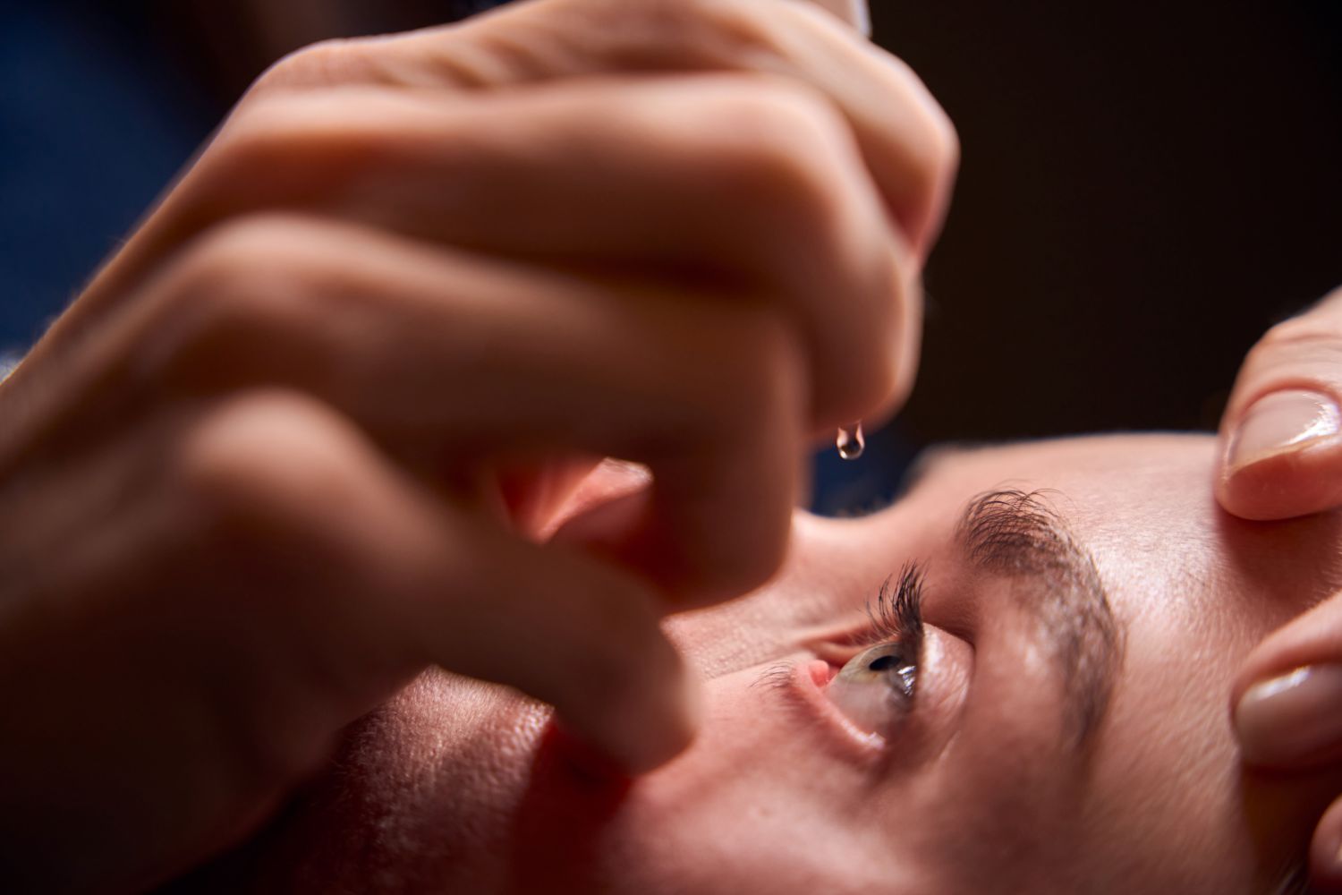 woman using eye drops